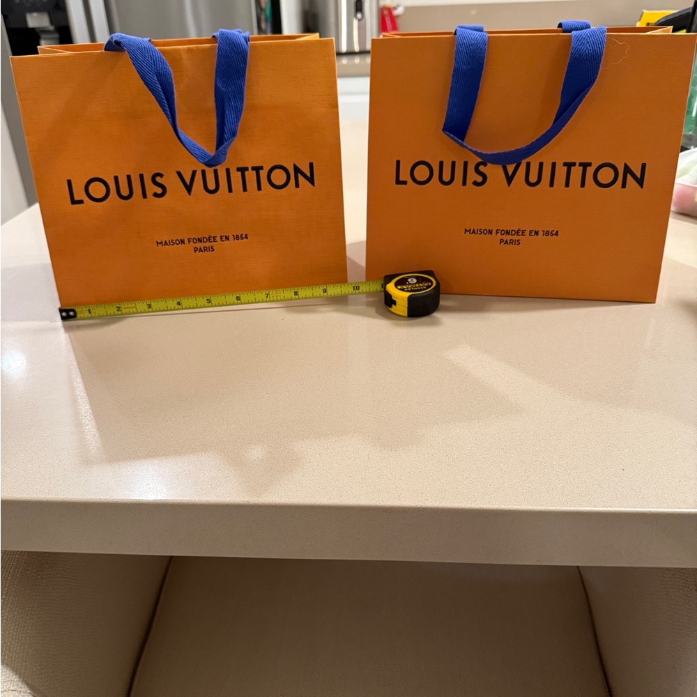 Louis Vuitton Vibrant Orange Bags with Bold Blue Handles